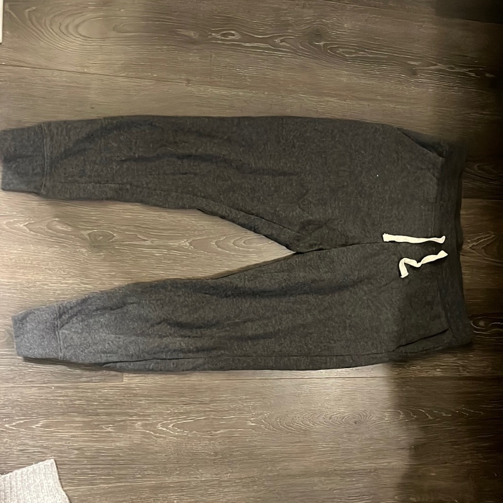 Dark grey joggers. Ankles are cuffed